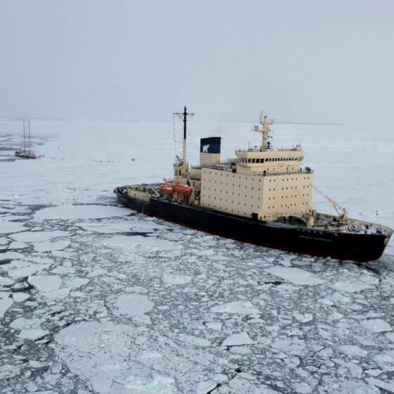 Robust icebreaker navigating through frozen waters, powered by a Samlex boat power inverter for consistent power in extreme conditions.