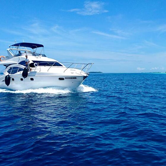 Motor yacht cruising on the open sea, equipped with a Samlex boat power inverter for stable energy supply during long voyages.