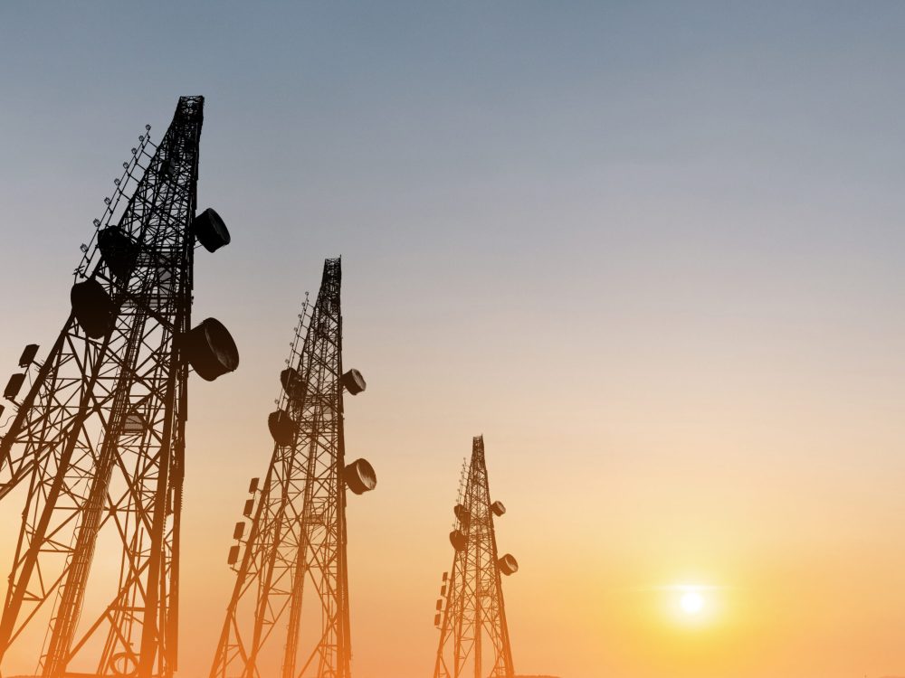 Silhouette,,Telecommunication,Towers,With,Tv,Antennas,And,Satellite,Dish,In